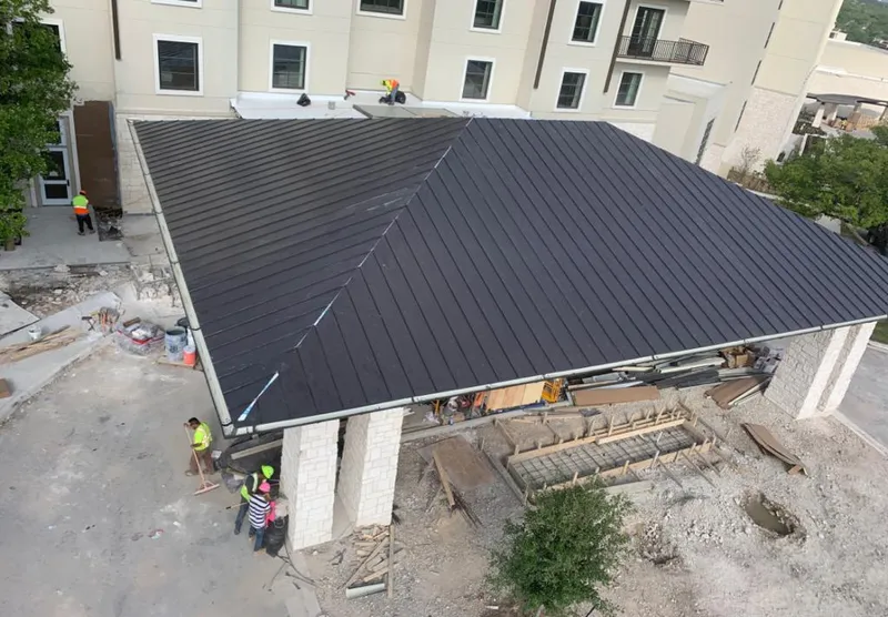 Metal roofing installation team working on a commercial building in Erwin
